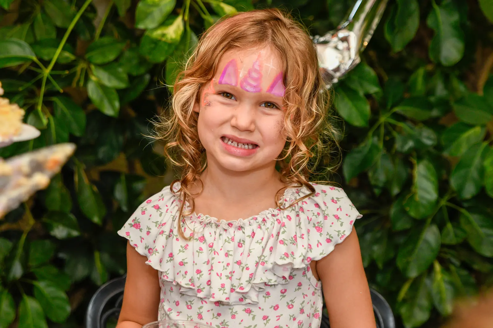 Child smiling in a garden