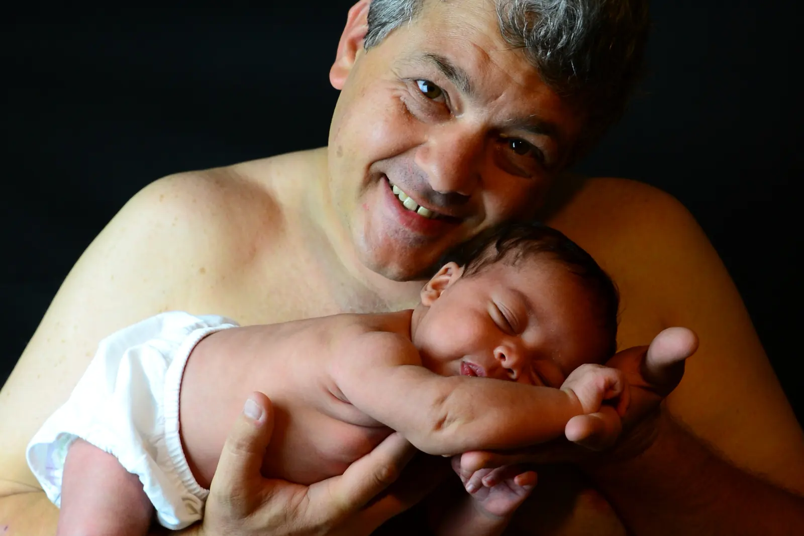 Tender portrait of a parent and newborn